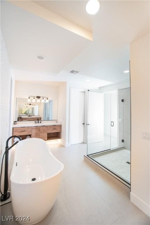 bathroom featuring vanity and independent shower and bath