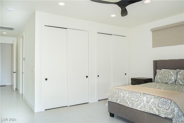 bedroom featuring multiple closets and ceiling fan