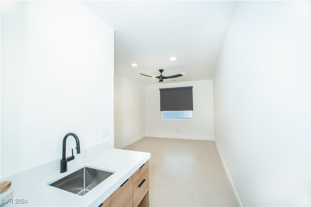 kitchen featuring ceiling fan and sink