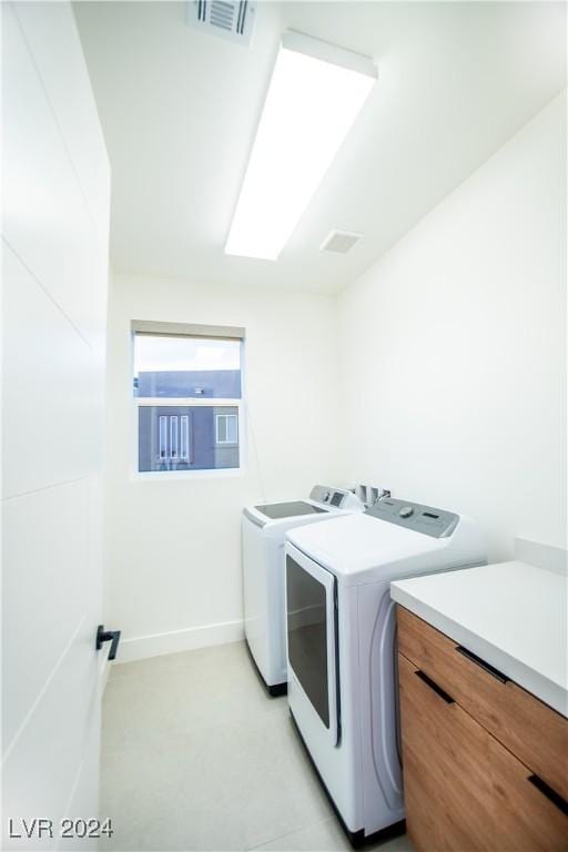 laundry area with a skylight and washing machine and clothes dryer