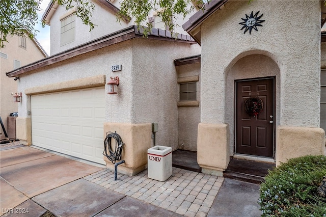 view of exterior entry with a garage