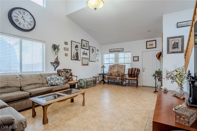 living room featuring light tile patterned floors and vaulted ceiling