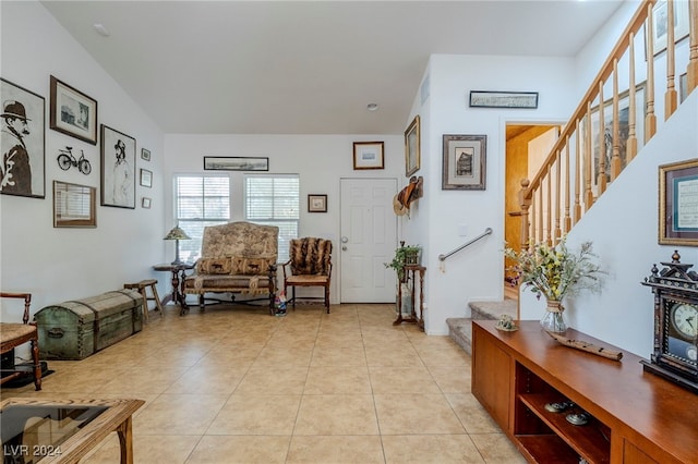 tiled living room featuring vaulted ceiling