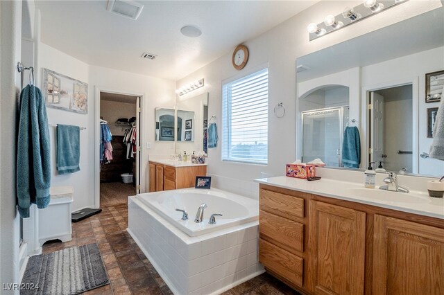 bathroom with vanity and plus walk in shower