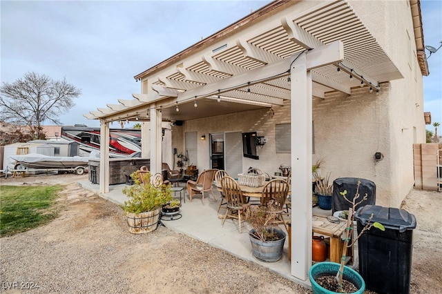 view of patio with a pergola and a hot tub