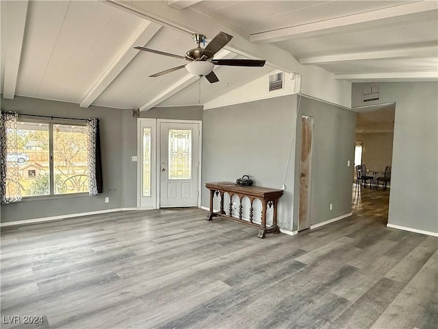 foyer entrance featuring hardwood / wood-style flooring, vaulted ceiling with beams, and ceiling fan