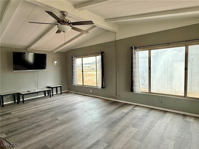 unfurnished living room featuring hardwood / wood-style flooring, lofted ceiling with beams, and ceiling fan