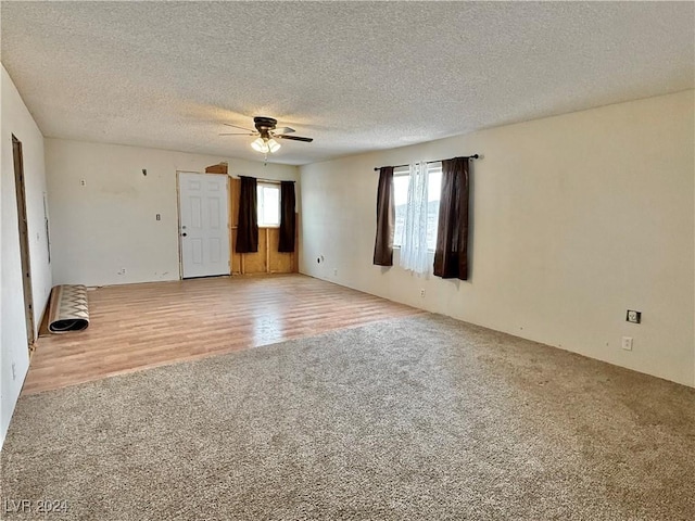 unfurnished room featuring ceiling fan, wood-type flooring, and a textured ceiling