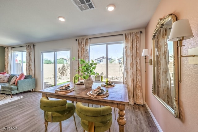 dining area with hardwood / wood-style flooring and a healthy amount of sunlight