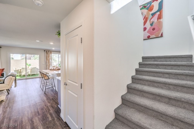 stairs featuring wood-type flooring