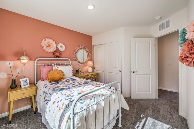 bedroom featuring dark colored carpet and a closet