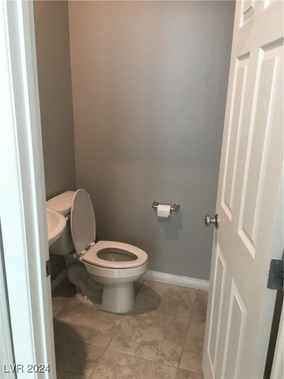 bathroom with tile patterned flooring and toilet