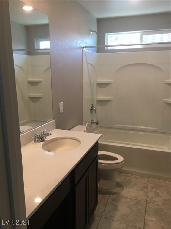 full bathroom with washtub / shower combination, vanity, toilet, and tile patterned flooring