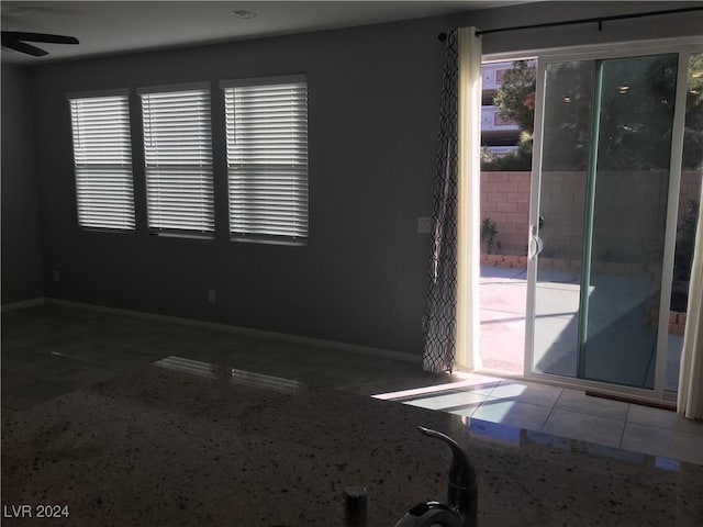 spare room with tile patterned floors and ceiling fan