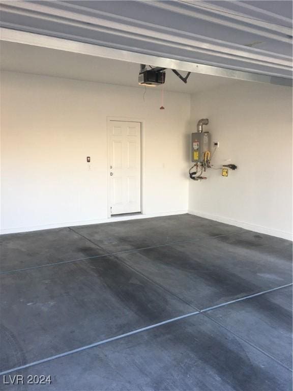 garage with a garage door opener and water heater