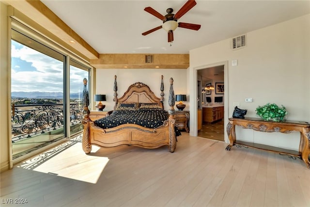 bedroom featuring access to exterior, connected bathroom, ceiling fan, and light wood-type flooring