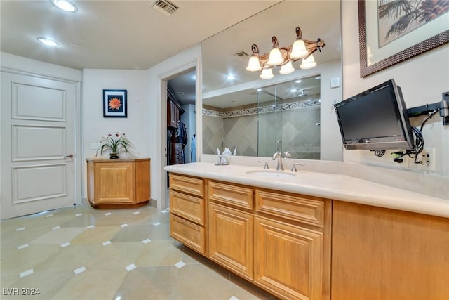 bathroom with vanity, tile patterned floors, and a shower with shower door