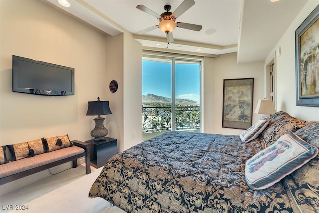 bedroom with access to exterior, ceiling fan, carpet floors, and a mountain view