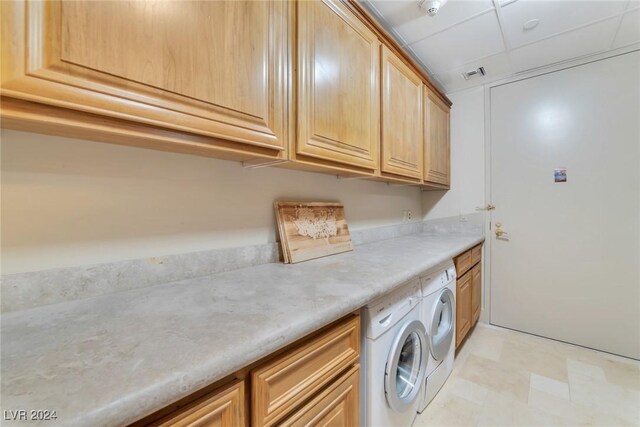 laundry area with cabinets and separate washer and dryer