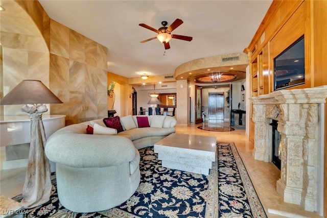 living room with ceiling fan, a fireplace, and light tile patterned flooring