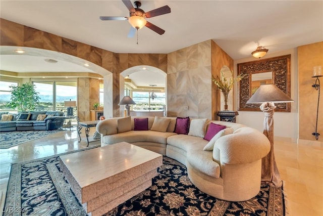 living room featuring tile patterned floors, a wealth of natural light, and ceiling fan