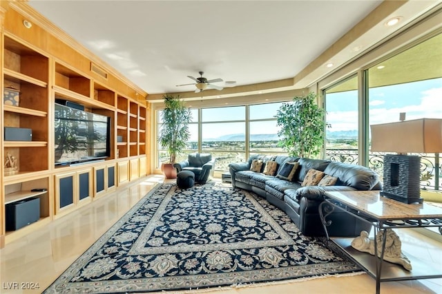 tiled living room featuring plenty of natural light and ceiling fan