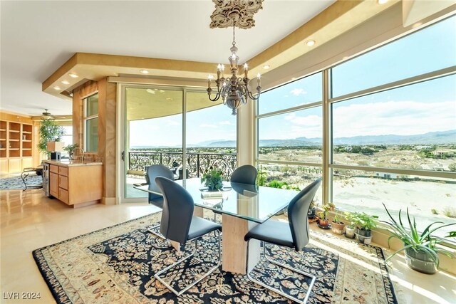 sunroom featuring a chandelier, a mountain view, and sink