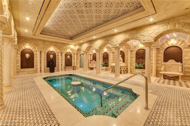 view of swimming pool featuring ornate columns