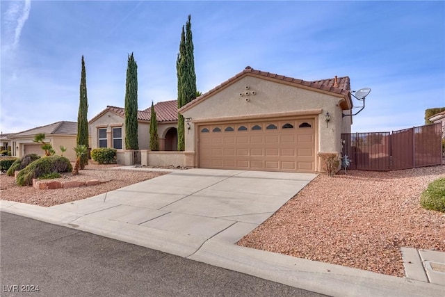 mediterranean / spanish-style home with a garage