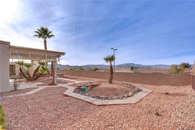 view of yard featuring a mountain view and a pergola