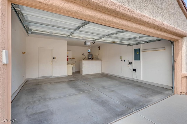 garage featuring electric panel and a garage door opener