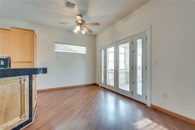 interior space featuring ceiling fan, french doors, and light hardwood / wood-style floors