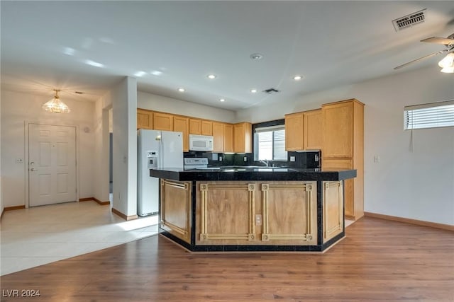 kitchen with tasteful backsplash, white appliances, ceiling fan, sink, and light hardwood / wood-style floors