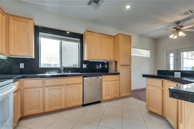 kitchen featuring backsplash, a wealth of natural light, dishwasher, and sink