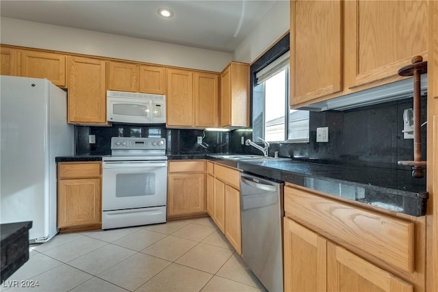 kitchen with sink, light tile patterned floors, white appliances, and backsplash