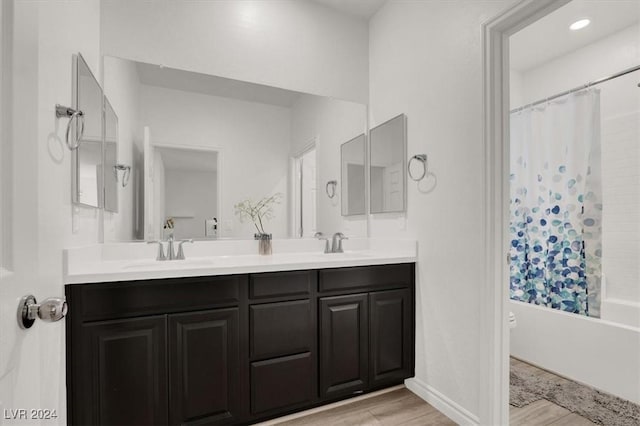 bathroom featuring shower / bath combination with curtain, wood-type flooring, and vanity