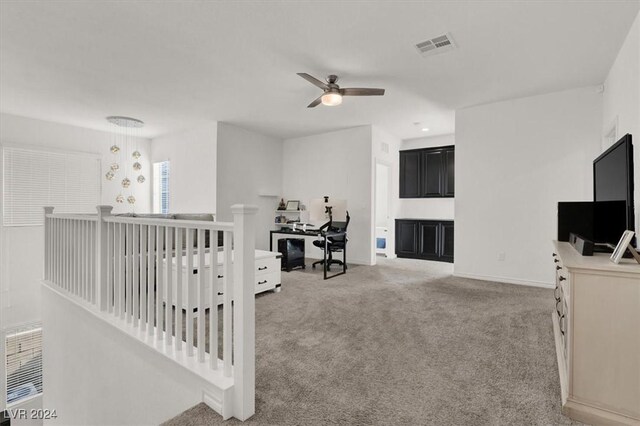 interior space featuring light carpet and a chandelier