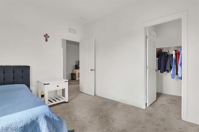 bedroom with light carpet and a closet