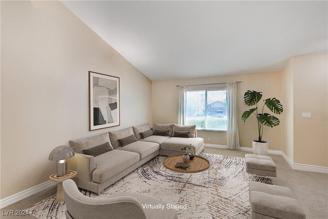 carpeted living room featuring vaulted ceiling