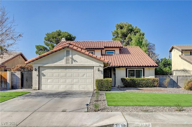 view of front of house with a front yard and a garage