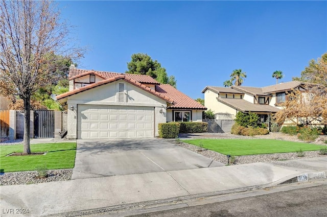 view of front of property featuring a garage and a front yard