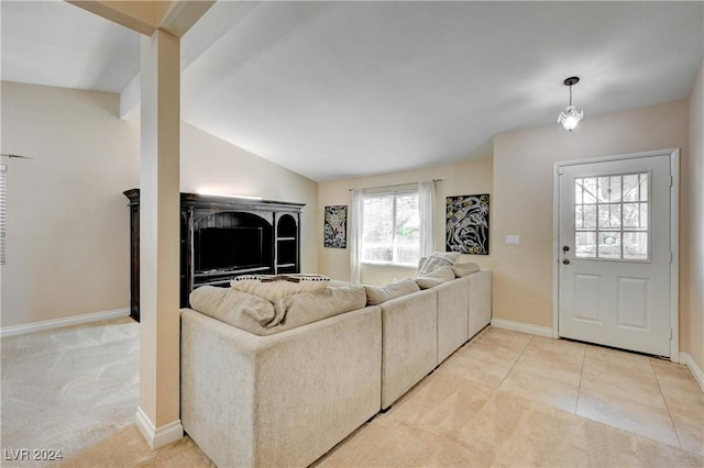 carpeted living room with vaulted ceiling