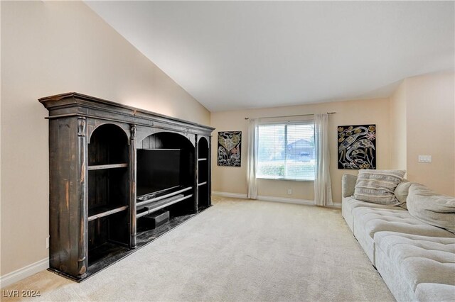 living room with carpet floors and vaulted ceiling