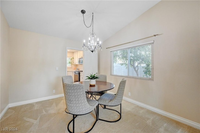 carpeted dining room featuring a notable chandelier and vaulted ceiling