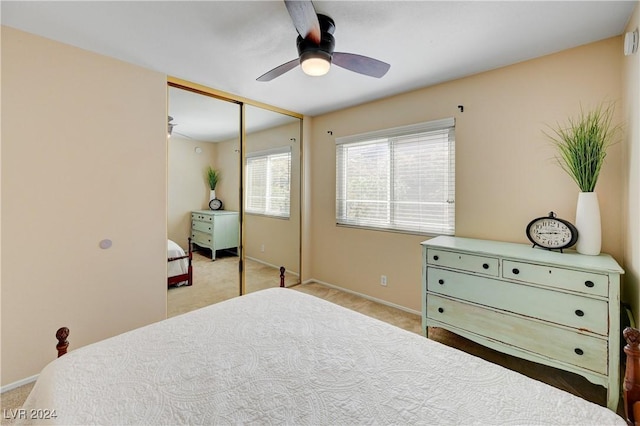 carpeted bedroom with ceiling fan and a closet