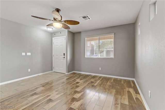 empty room featuring ceiling fan and light hardwood / wood-style flooring