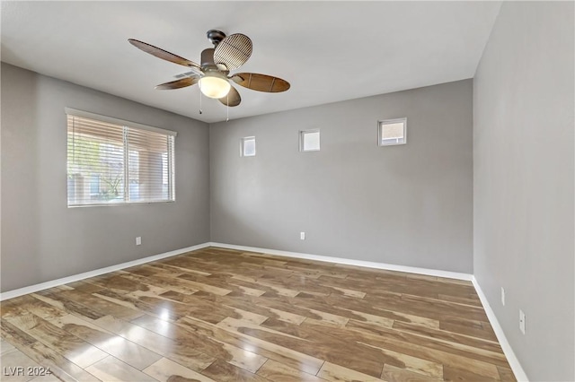 empty room featuring hardwood / wood-style flooring and ceiling fan