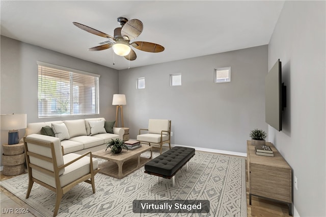 living room with light hardwood / wood-style floors and ceiling fan