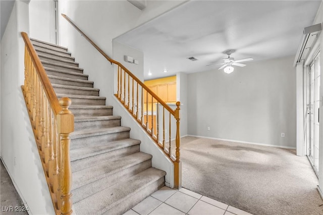 stairs featuring carpet flooring and ceiling fan