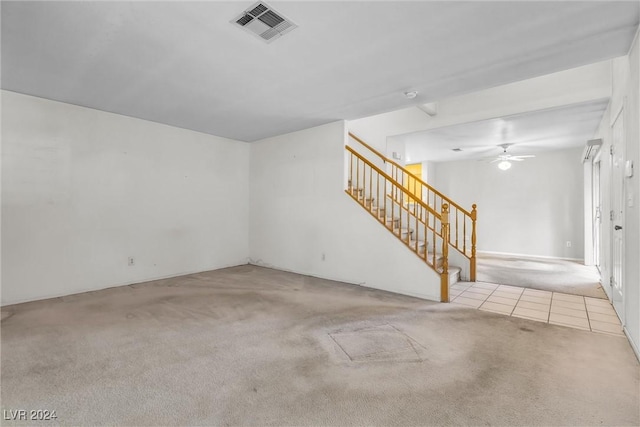 interior space with ceiling fan and light colored carpet